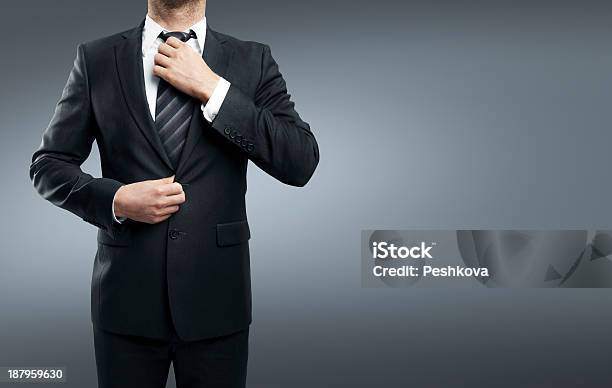 Businessman Adjusts His Tie Stock Photo - Download Image Now - Adult, Beautiful People, Beauty