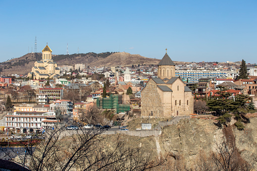 Tbilisi, Georgia - ‎‎‎February 11, 2020 : View Of Residential Local Houses With Holy Trinity Cathedral Of Tbilisi And Metekhi Church In Central City.