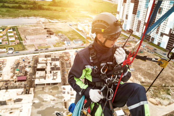 istock Industrial mountaineering worker in uniform with walkie-talkie 1879635095