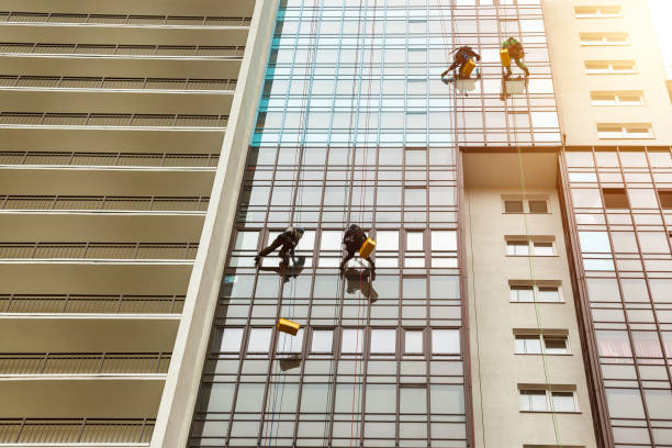 istock Industrial mountaineering workers hangs over residential facade building 1879635098