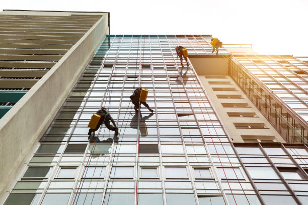 istock Industrial mountaineering workers hangs over residential facade building 1879635102