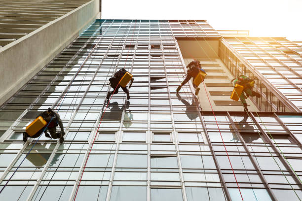 istock Industrial mountaineering workers hangs over residential facade building 1879635106