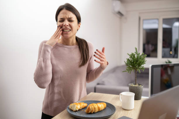 istock Woman having toothache at home 1879650724