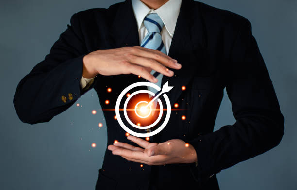 Businessman holding virtual dartboard and arrow for setup business objective target concept. with copy space.