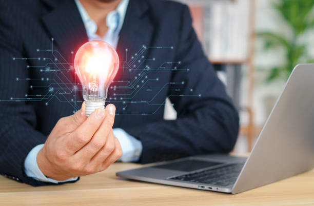 istock Man holding a light bulb. New ideas with technological innovation and creativity and innovation new beginning. 1879696701