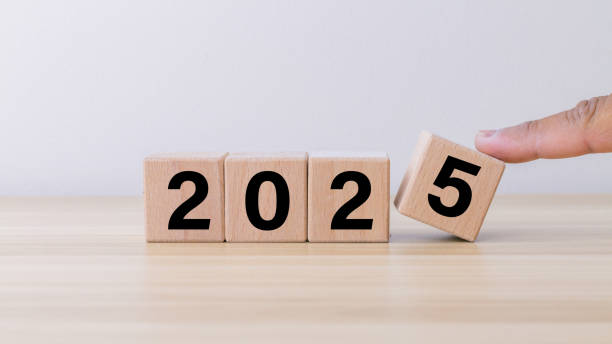 istock wooden cube year 2025 on wooden table. 1879710604