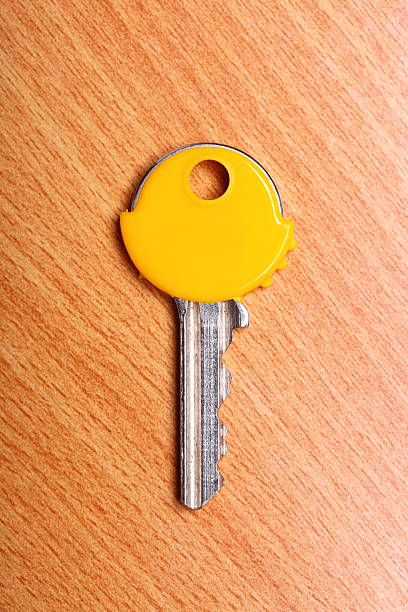 istock House key with yellow plastic coats caps on table 187972340