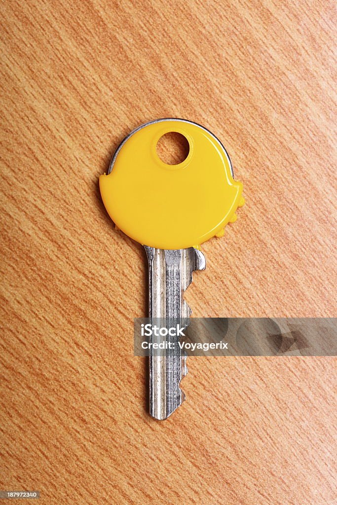 House key with yellow plastic coats caps on table House key with yellow plastic coats caps on wooden table background. Cap - Hat Stock Photo