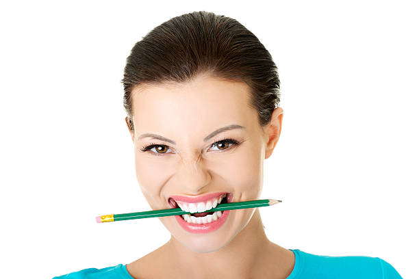 Casual woman with pencil in mouth. stock photo