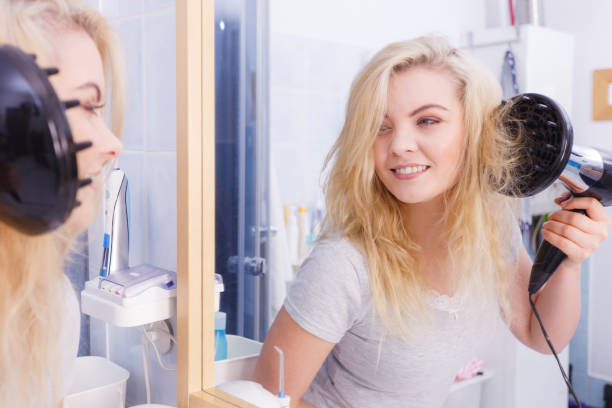 istock Woman doing curls with hairdryer diffuser 1879726615