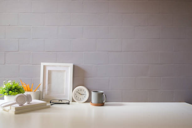 Warm home workspace with blurred computer monitors, natural window light, and desk accessories. Ideal for background use in tech content, productivity, or remote work themes.