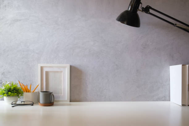 istock Minimal workspace with book, coffee cup and pencil holder on white table. Copy space for your advertising text. 1879747700