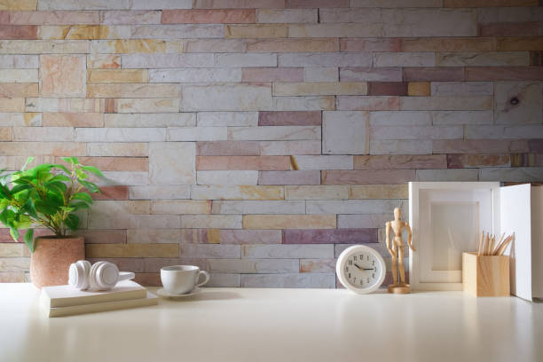 Minimal workspace with book, coffee cup and pencil holder on white table. Copy space for your advertising text.