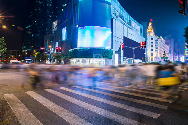 scenery of the city, crossing at night, burred crowd shanghai crossing at night. Night Shopping. Long exposure, blurred crowd. burred stock pictures, royalty-free photos & images