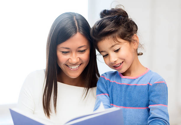 istock Mother and daughter reading a book 187975365