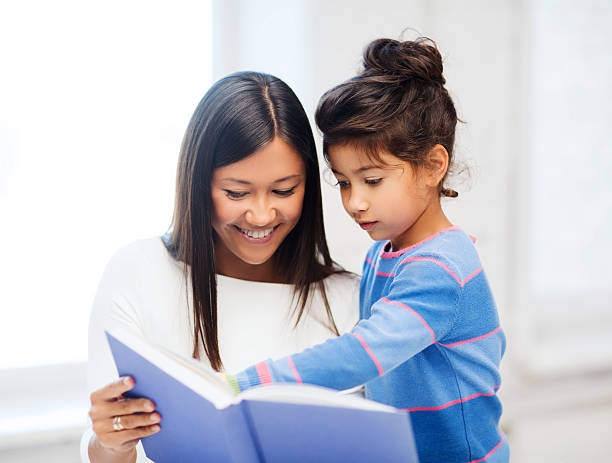 istock mother and daughter with book 187975489