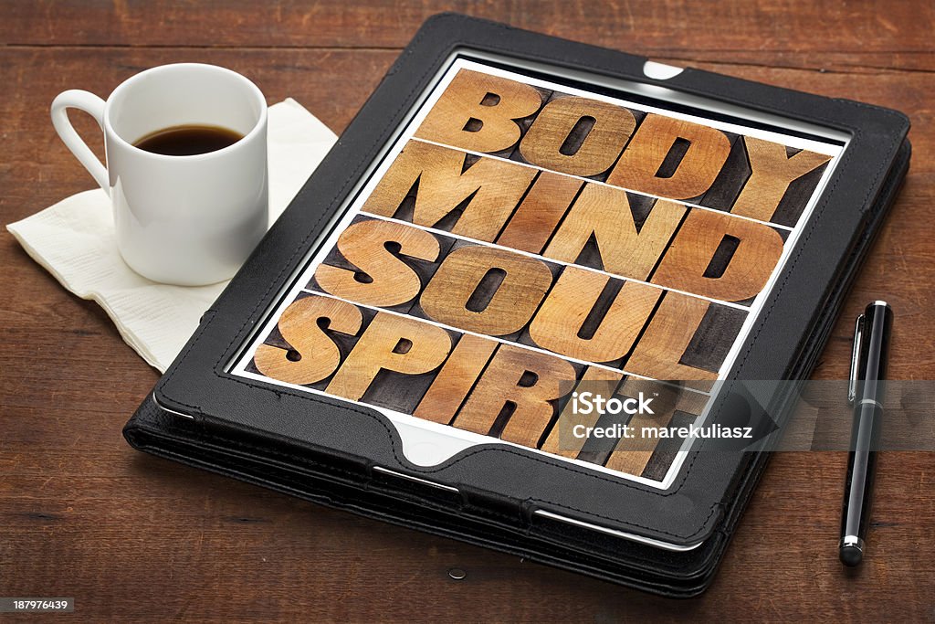 mind, body, soul and spirit mind, body, soul and spirit - wellness concept - a collage of words in letterpress wood type on a digital tablet with cup of coffee Coffee - Drink Stock Photo