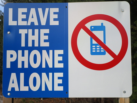 road sign warning against use of cell phone while driving