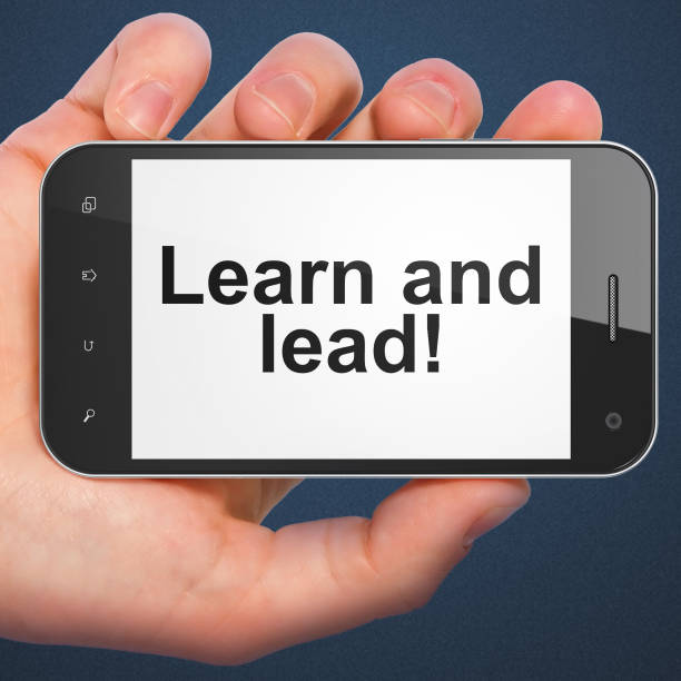 istock Hand holding smartphone with word Learn and lead 187978754