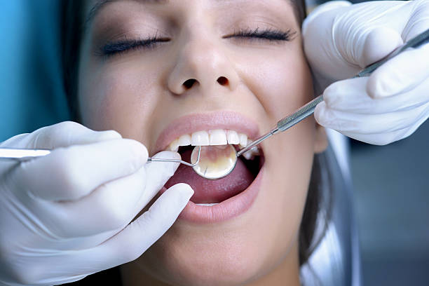 istock Beautiful young woman visiting dentist for dental checkup 187979005