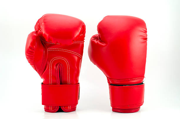 red boxing gloves на серый фон - boxing glove sports glove hanging combative sport стоковые фото и изображения