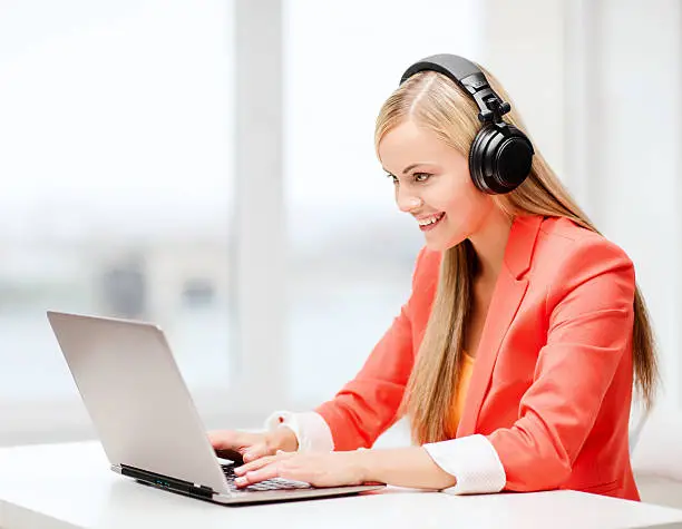 Photo of happy woman with headphones listening to music