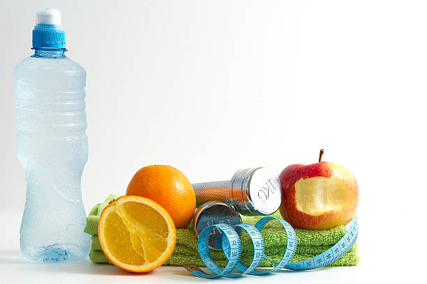 istock Fitness dumbbell with fruit and water on white background. 187980246