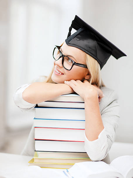istock student girl  in bachelor cap with books 187980331