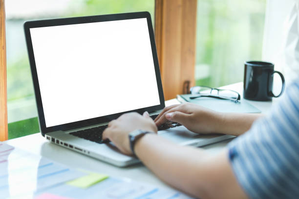 istock Over shoulder view of male freelancer working online, typing email on laptop computer. 1879803705