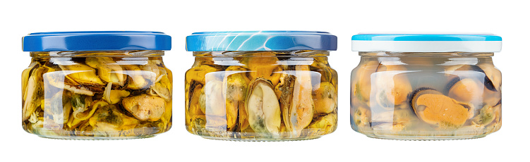Glasses jars with conserved mussels isolated on the white background. File contains clipping path.