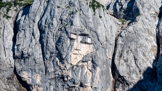 Image of a womans face known as The Pagan girl in the majestic rocks of Prisank mountain in Slovenia, Europe.