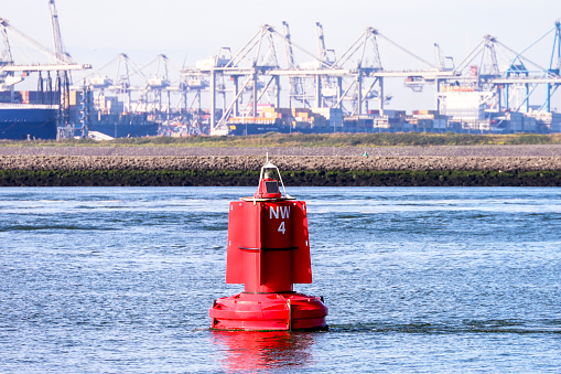 Red buoy on the Nieuwe Waterweg canal in Hoek van Holland in the Netherlands