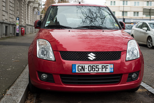 Mulhouse - France - 24 December 2023 - Front view of red suzuki swift parked in the street