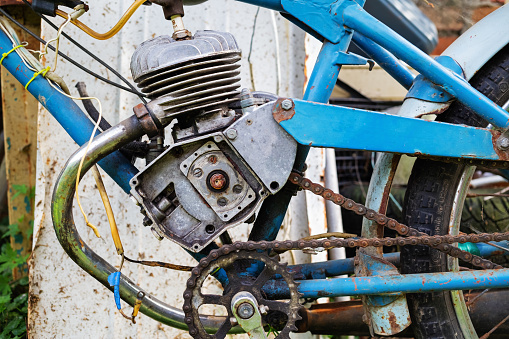 Side view of the engine of an old vintage moped.