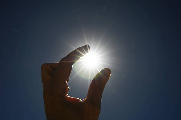 istock One Hand Catching the Sun Stars on a Blue Background 187986315