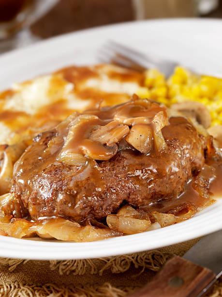 Salisbury Steak Salisbury Steak with Sauteed Mushrooms and Onions, Mashed Potatoes and Corn on the side and topped with Gravy. - Photographed on Hasselblad H3D2-39mb Camera salisbury steak stock pictures, royalty-free photos & images