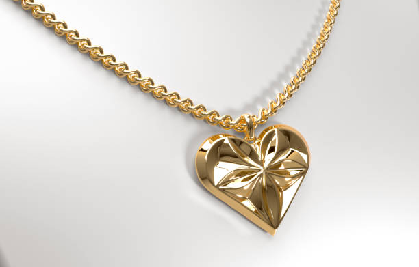 istock Gold heart-shaped pendant with floral pattern on a chain 1879877250