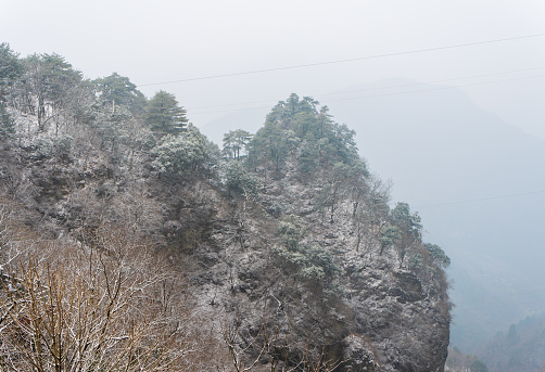 Ancient buildings in China's Wudang Mountains are elegantly decorated with a layer of snow, presenting a harmonious blend of nature and architecture.