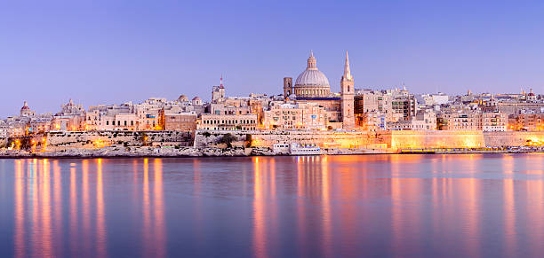 St Pauls Anglican Cathedral and Carmelite Church at Valletta Malta The harbour and St. Paul's Anglican Cathedral and Carmelite Church at Valetta, Malta at twilight. valletta photos stock pictures, royalty-free photos & images