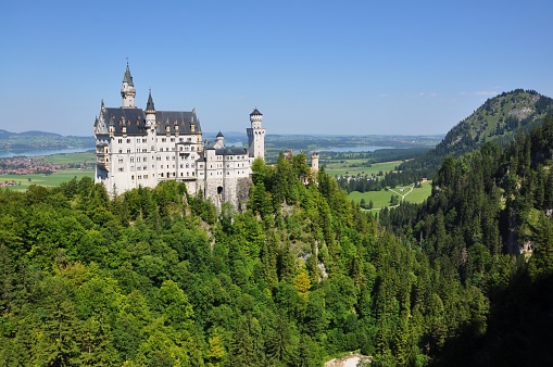 Beautiful view of world-famous Neuschwanstein Castle, the nineteenth-century Romanesque Revival palace built for King Ludwig II on a rugged cliff, with scenic mountain landscape near Fussen, southwest Bavaria, Germany