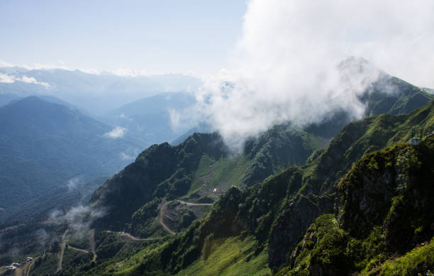 istock large white cloud on top of a mountain on a sunny summer day 1879888723