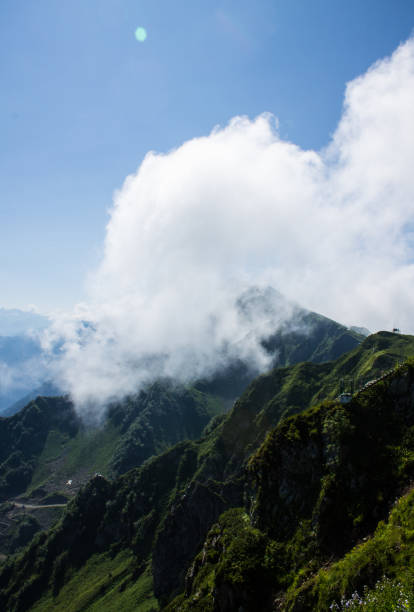 istock large white cloud on top of a mountain on a sunny summer day 1879888751