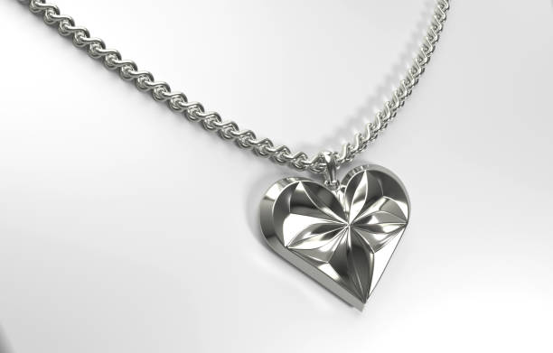 istock Silver heart shaped pendant with floral pattern on a chain 1879896499