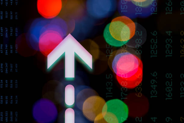 Graphic composition of arrow symbols and  data over abstract blurred lights. Dark background.