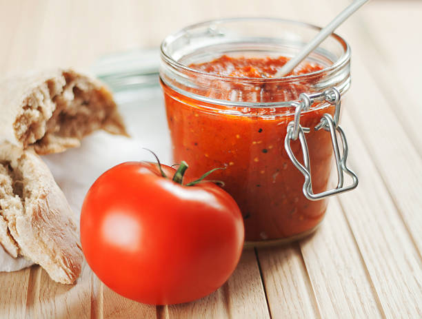 Homemade Bell Pepper Chutney Homemade type of chutney or relish, made from red bell peppers, with garlic and eggplant. Called Ajvar in the Balkans. chutney stock pictures, royalty-free photos & images