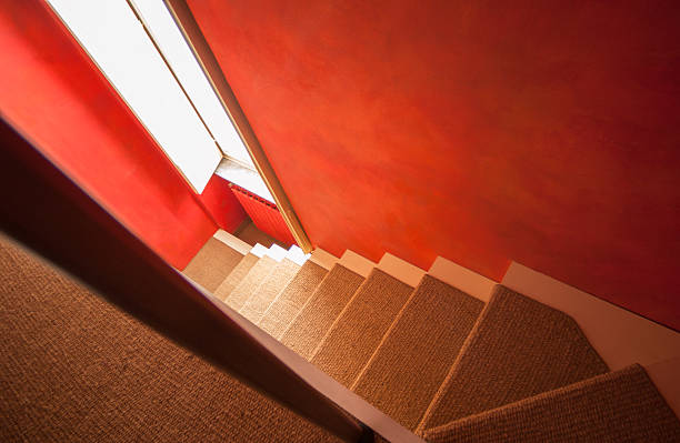 istock White stair coated with sand coloured moquette, red wall 187990300