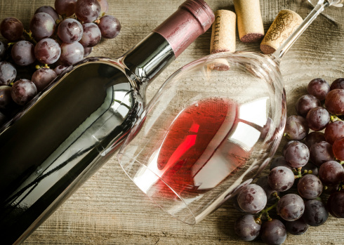 Still life photo of grapes, wine bottle and wine glass