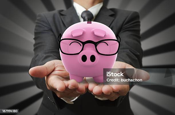 Businessman Shows A Piggy Bank Stock Photo - Download Image Now - Bank Deposit Slip, Banking, Business