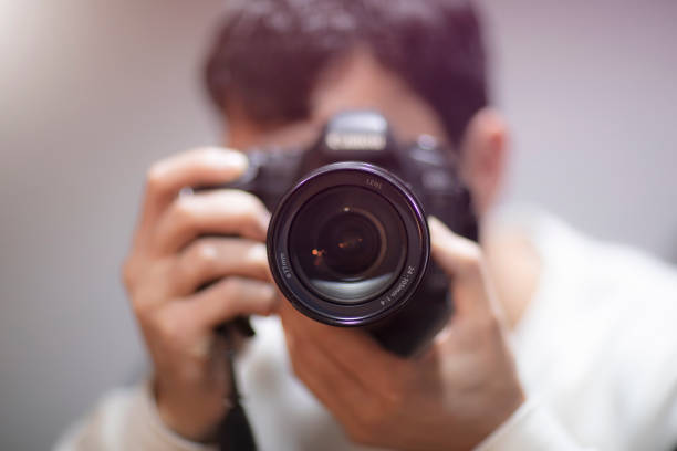 istock photographer working in a photo studio 1879989384