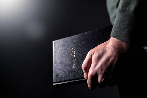 istock Man holding holy bible 1879996490